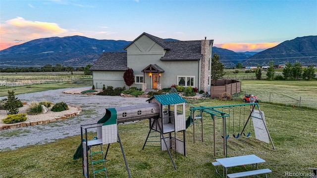 10757 Vista Farms Ct, Salida, CO 81201 - view of front facade with a mountain view, stucco siding, and a view of rural / pastoral area