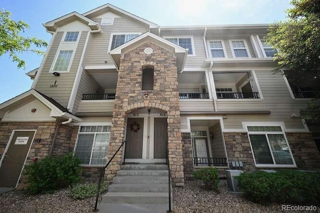 12711 Colorado Blvd Unit 914, Thornton, CO 80241 - view of property featuring stone siding and a balcony
