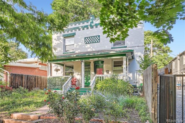 1612 N High St, Denver, CO 80218 - victorian house featuring covered porch and brick siding