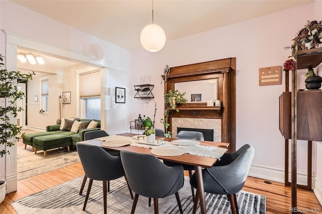 1612 N High St, Denver, CO 80218 - dining area with light wood finished floors and a fireplace