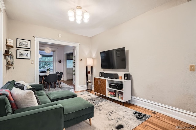 1612 N High St, Denver, CO 80218 - living area featuring light wood-style flooring and a chandelier