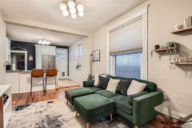 1612 N High St, Denver, CO 80218 - living area featuring light wood-type flooring, a chandelier, healthy amount of natural light, and a textured wall