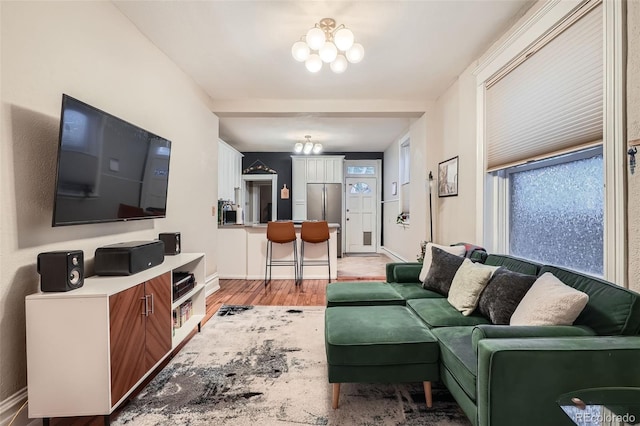 1612 N High St, Denver, CO 80218 - living room with a chandelier and light wood finished floors