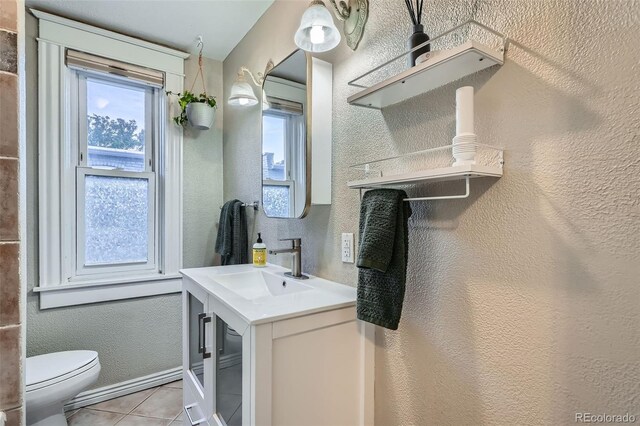1612 N High St, Denver, CO 80218 - bathroom featuring vanity, tile patterned floors, and a textured wall