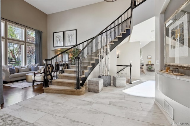17490 W 67th Ave, Arvada, CO 80007 - staircase with a high ceiling and marble look tile flooring