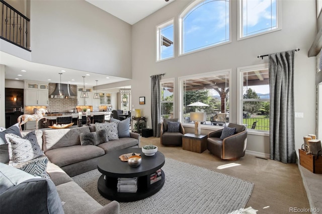 17490 W 67th Ave, Arvada, CO 80007 - living area with a towering ceiling, light carpet, plenty of natural light, and baseboards