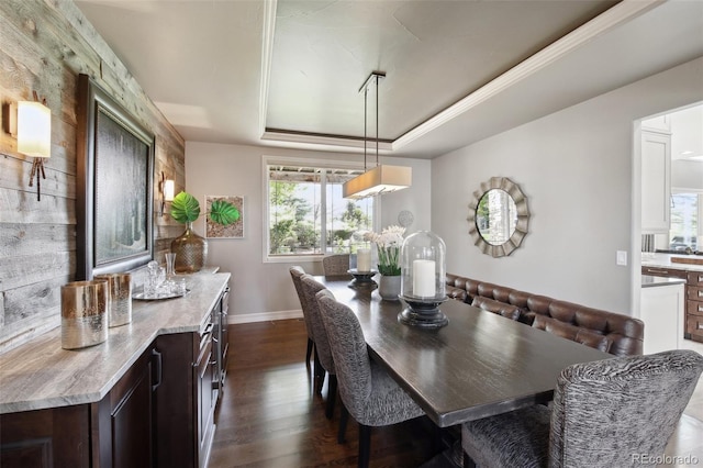 17490 W 67th Ave, Arvada, CO 80007 - dining space featuring a raised ceiling, dark wood-style floors, and baseboards