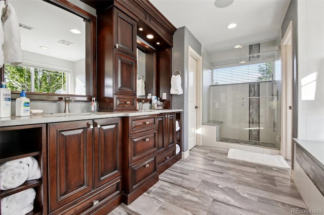 17490 W 67th Ave, Arvada, CO 80007 - full bathroom featuring a shower stall, double vanity, and recessed lighting