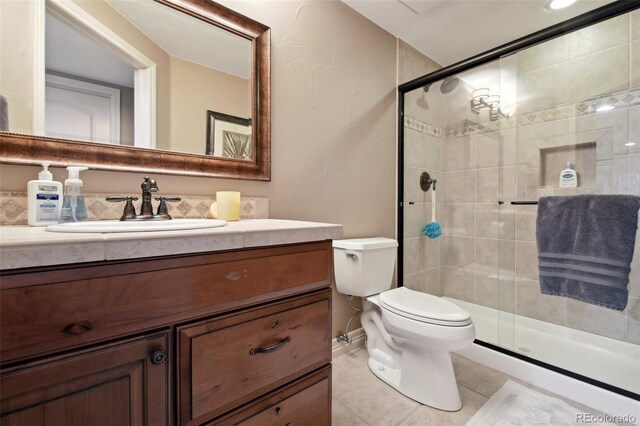 17490 W 67th Ave, Arvada, CO 80007 - bathroom with a shower stall, vanity, toilet, and tile patterned flooring