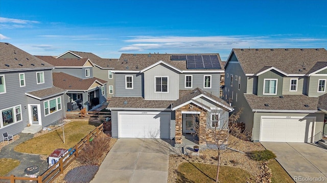 view of front facade featuring solar panels and a garage