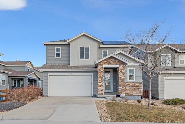 view of front of home with solar panels and a garage