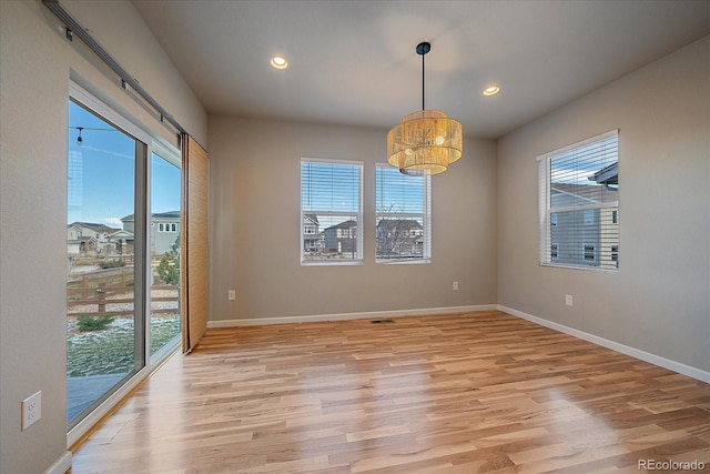 unfurnished dining area with light wood-type flooring