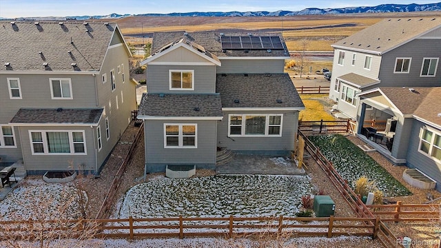 back of property with a mountain view