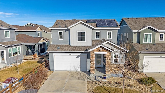 view of front facade with a garage and solar panels