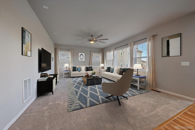 living room with light hardwood / wood-style floors and ceiling fan