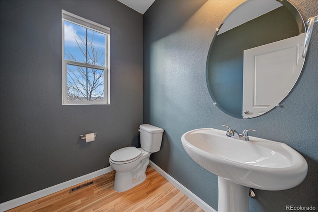 bathroom featuring hardwood / wood-style floors, sink, and toilet