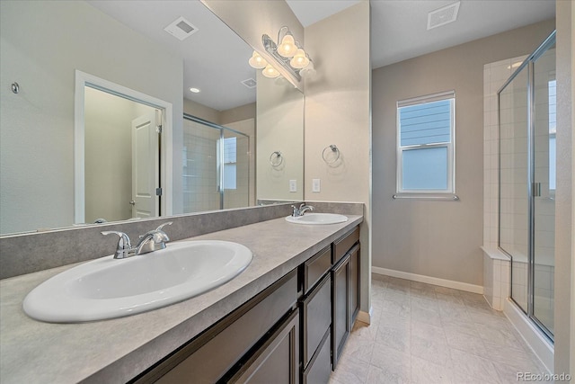 bathroom with vanity and a shower with shower door