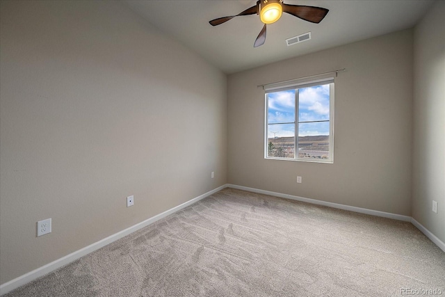 empty room featuring vaulted ceiling, ceiling fan, and carpet