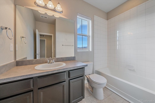 full bathroom featuring tiled shower / bath combo, vanity, and toilet