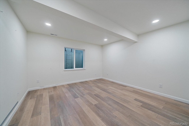 empty room with light hardwood / wood-style flooring