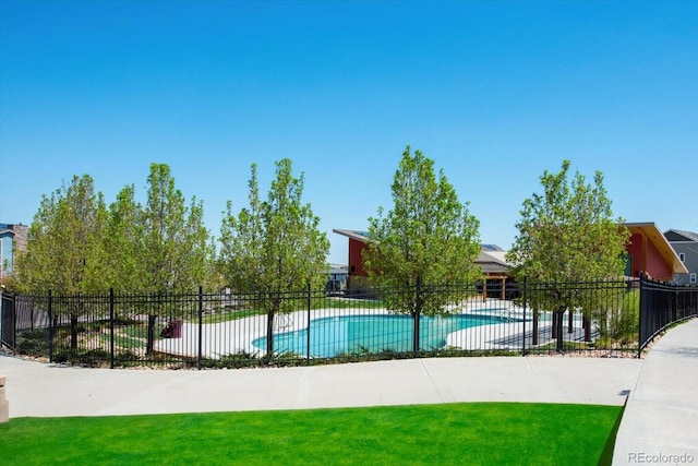 view of pool with a patio and a yard