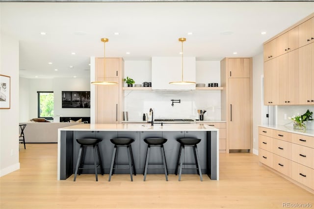 1462 S Vine St, Denver, CO 80210 - kitchen with open shelves, light brown cabinetry, light wood-style floors, light countertops, and recessed lighting