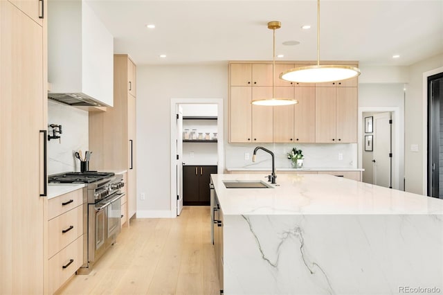1462 S Vine St, Denver, CO 80210 - kitchen with light brown cabinetry, high end range, light wood-style flooring, modern cabinets, and recessed lighting