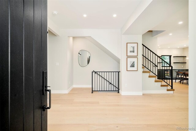 1462 S Vine St, Denver, CO 80210 - foyer entrance with light wood finished floors, recessed lighting, and stairs