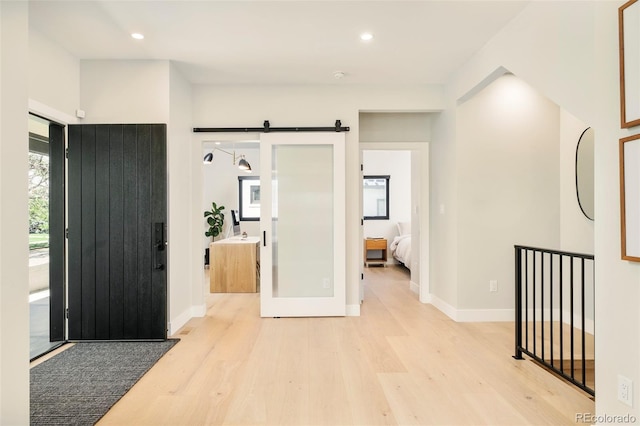 1462 S Vine St, Denver, CO 80210 - entrance foyer featuring light wood-type flooring, recessed lighting, and a barn door