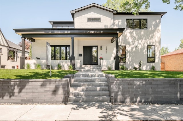 1462 S Vine St, Denver, CO 80210 - view of front of home featuring covered porch, a front lawn, stucco siding, and brick siding