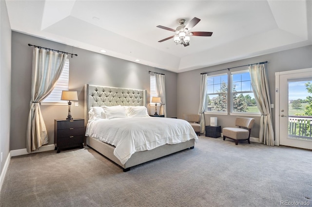 7963 S Valleyhead Way, Aurora, CO 80016 - bedroom featuring a tray ceiling, access to exterior, carpet floors, baseboards, and recessed lighting