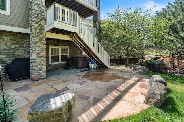 7963 S Valleyhead Way, Aurora, CO 80016 - view of patio / terrace with a hot tub, stairway, a balcony, and area for grilling
