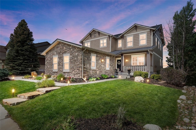 7963 S Valleyhead Way, Aurora, CO 80016 - craftsman house with covered porch, a lawn, and stone siding