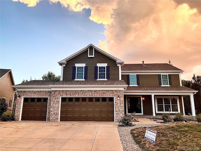 20460 Oakbrook Ln, Parker, CO 80138 - view of front of house featuring driveway, an attached garage, a porch, stone siding, and roof with shingles