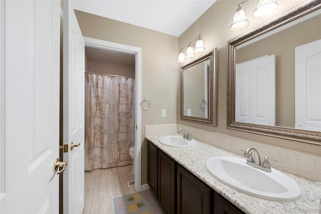 20460 Oakbrook Ln, Parker, CO 80138 - full bath featuring toilet, double vanity, and tasteful backsplash