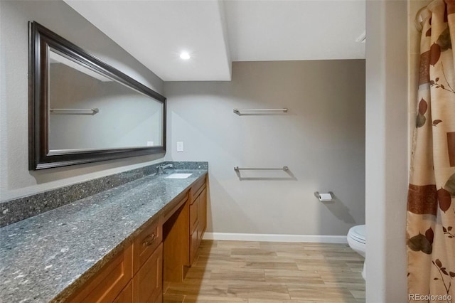 20460 Oakbrook Ln, Parker, CO 80138 - bathroom with toilet, vanity, wood finished floors, and baseboards