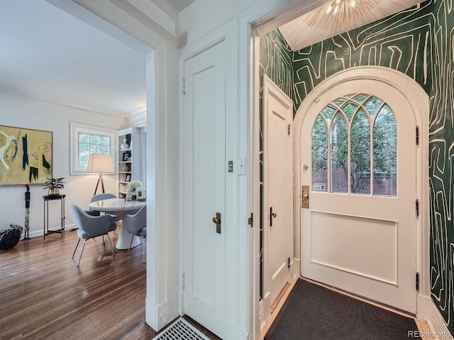 entryway featuring plenty of natural light, hardwood / wood-style floors, and crown molding