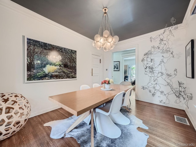 dining space featuring a notable chandelier, dark wood-type flooring, and crown molding