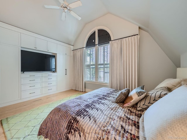 bedroom with ceiling fan, light hardwood / wood-style flooring, and lofted ceiling