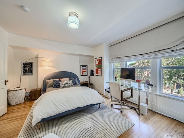 bedroom featuring light hardwood / wood-style flooring and multiple windows