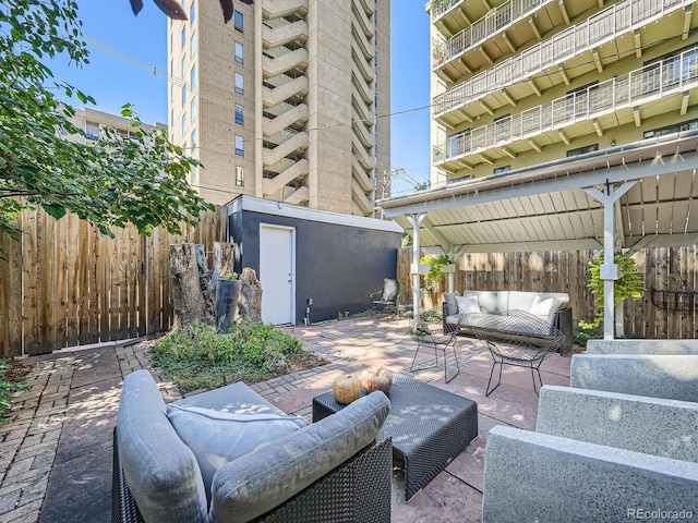 view of patio featuring a balcony and an outdoor living space