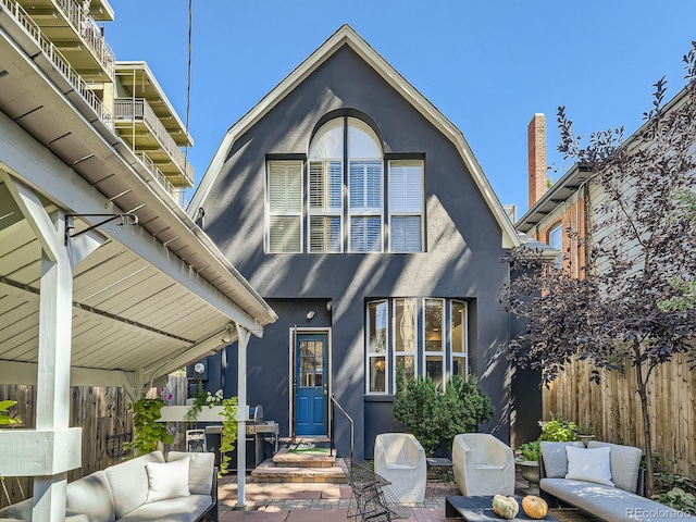 exterior space with a balcony, a patio, and an outdoor living space