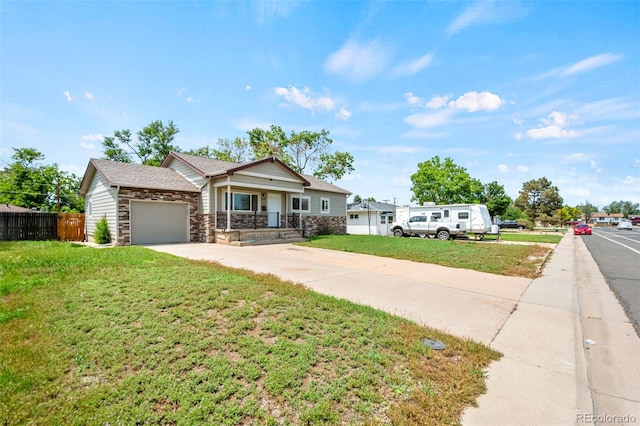 335 N 11th Ave, Brighton, CO 80601 - view of front facade featuring stone siding, concrete driveway, a garage, and a porch