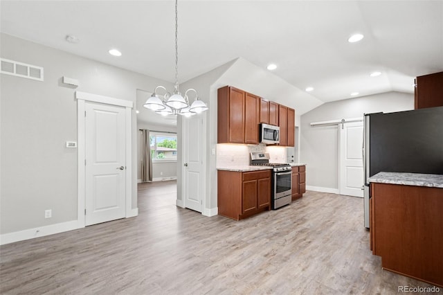 335 N 11th Ave, Brighton, CO 80601 - kitchen featuring stainless steel appliances, a barn door, a chandelier, recessed lighting, and decorative backsplash