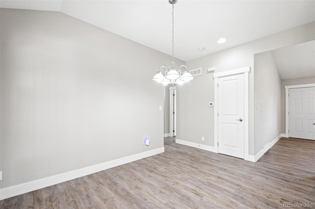 335 N 11th Ave, Brighton, CO 80601 - unfurnished dining area featuring a chandelier, lofted ceiling, wood finished floors, baseboards, and recessed lighting