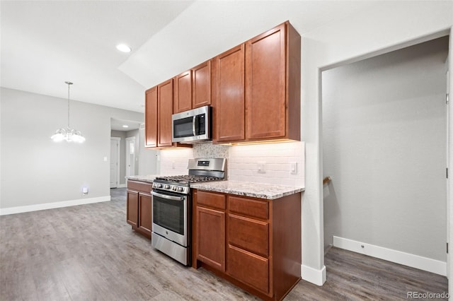 335 N 11th Ave, Brighton, CO 80601 - kitchen featuring stainless steel appliances, wood finished floors, decorative backsplash, baseboards, and recessed lighting