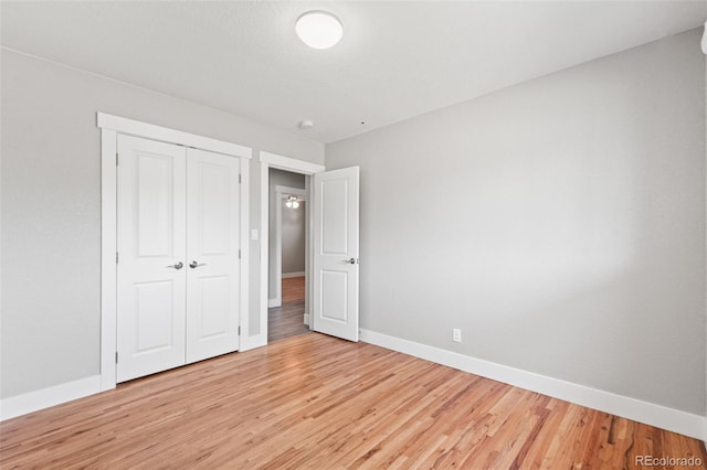335 N 11th Ave, Brighton, CO 80601 - unfurnished bedroom with baseboards, light wood-style flooring, and a closet