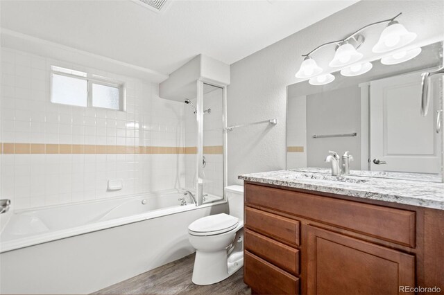 335 N 11th Ave, Brighton, CO 80601 - full bathroom featuring vanity, toilet, wood finished floors, and shower / washtub combination