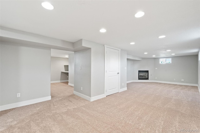 335 N 11th Ave, Brighton, CO 80601 - below grade area featuring light carpet, recessed lighting, baseboards, and a glass covered fireplace