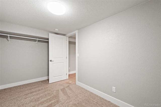 335 N 11th Ave, Brighton, CO 80601 - unfurnished bedroom featuring a textured ceiling, baseboards, light carpet, and a closet